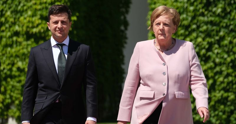 Angela Merkel shakes uncontrollably during ceremony welcoming Ukraine president, blames it on being 'just a bit dehydrated'