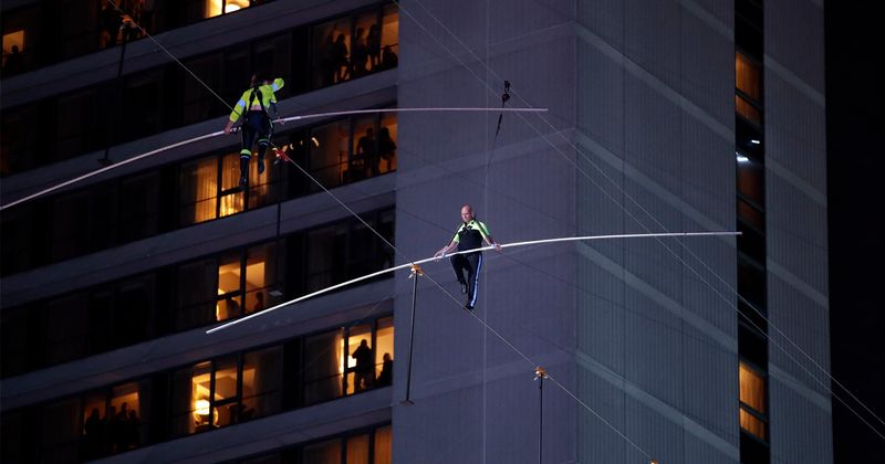 The Flying Wallendas cross Times Square on 1,300-foot long wire suspended 25 floors high in historic stunt