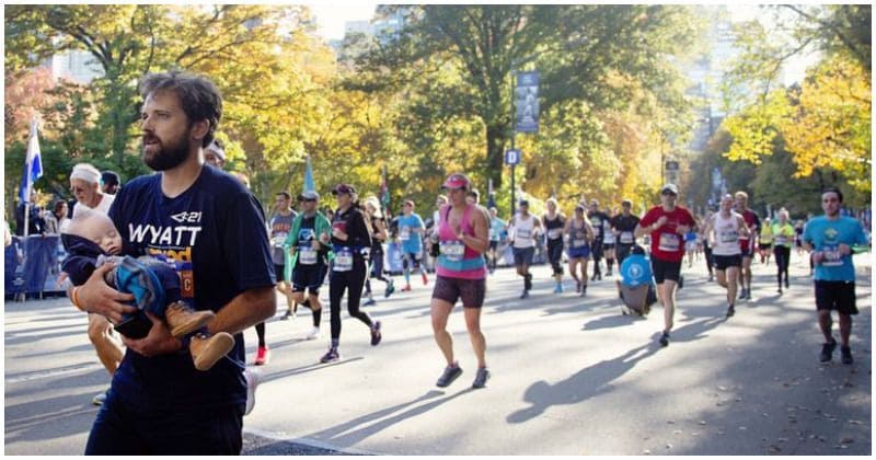 Spectators gasp as father carries 7-month-old son with Down Syndrome across marathon finish line