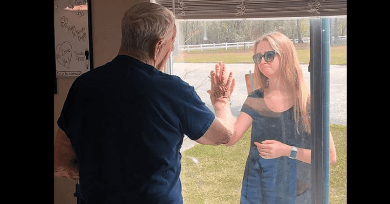 Coronavirus: Touching photo reveals woman showing engagement ring to grandfather through nursing home window