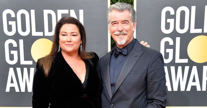 Pierce Brosnan goes shirtless and gives wife Keely a tender kiss as couple enjoy beach outing in Hawaii