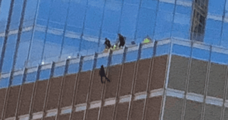Who is man dangling from Trump Tower? Onlookers think it's a ‘Batman’ stunt as Internet dubs him ‘QAnon person’