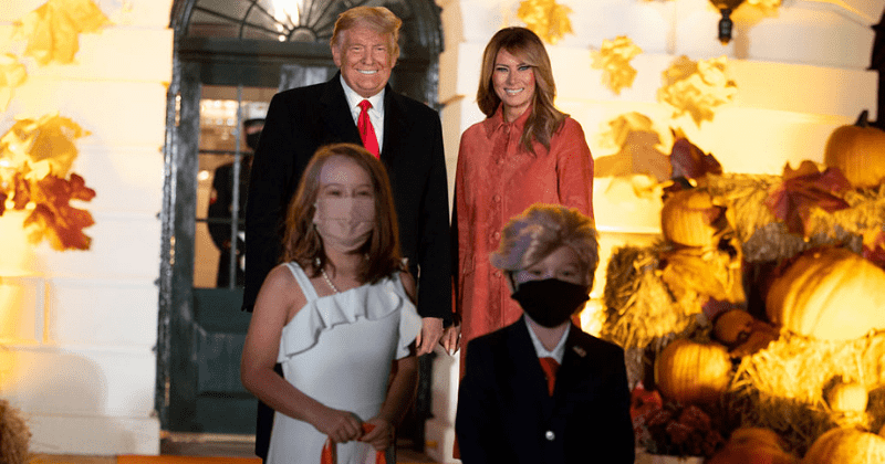 Trump and Melania smile as they pose with kids dressed as them at White House Halloween celebration