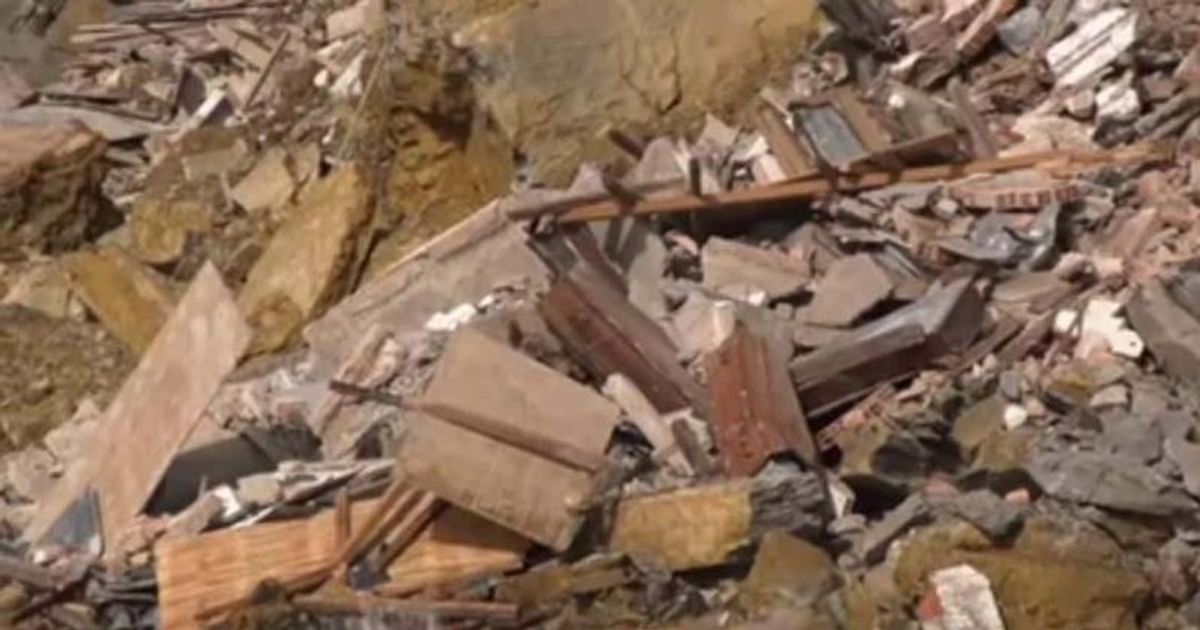 Bringing out the dead: Dozens of coffins seen dangling from ruins after eerie cemetery collapse