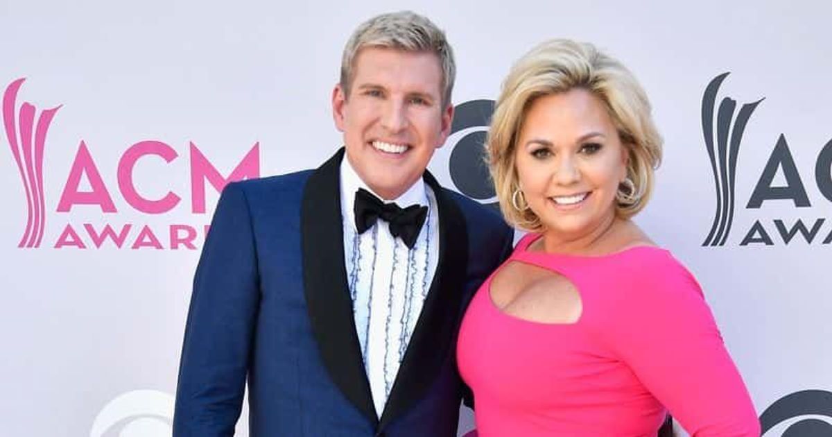 Todd Chrisley hides face with pillow as he and wife Julie reach prison to serve 12 and 7-year-sentences