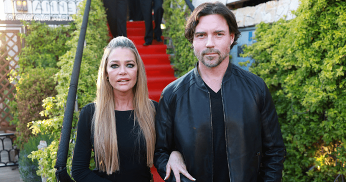 Denise Richards and husband Aaron Phypers look madly in love as they share steamy kiss while